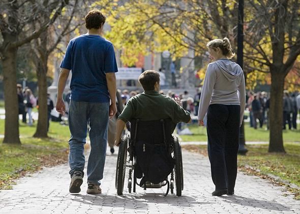 Wheelchair bound man with friends.
